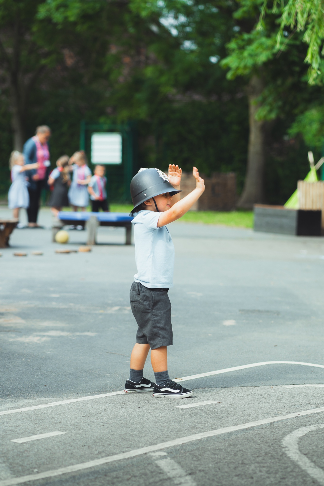 student in playground as pretend policeman
