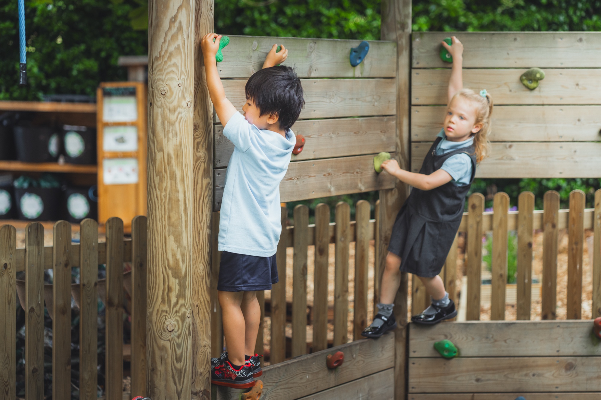 two students on climbing wall