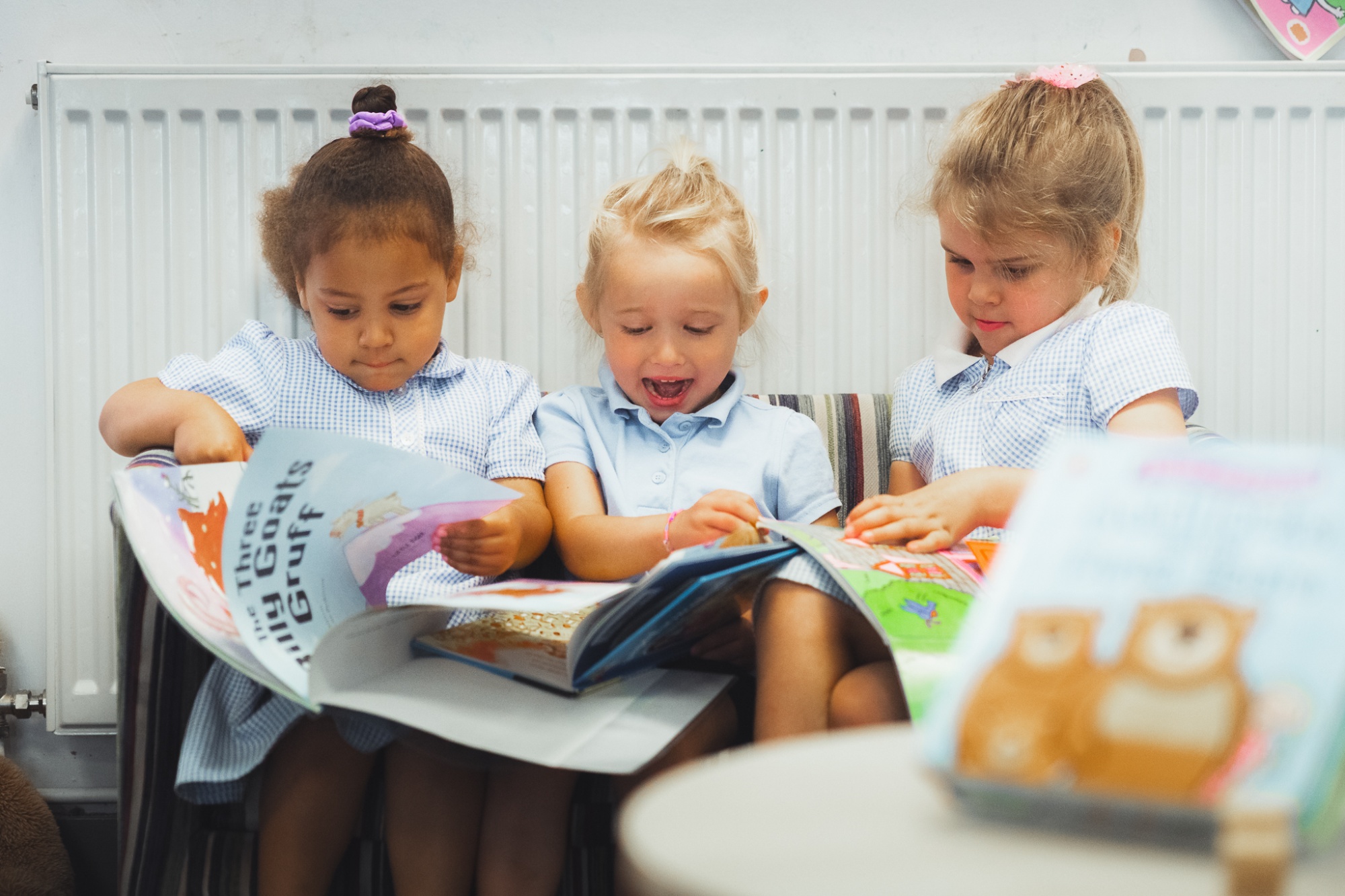 three students in reading corner